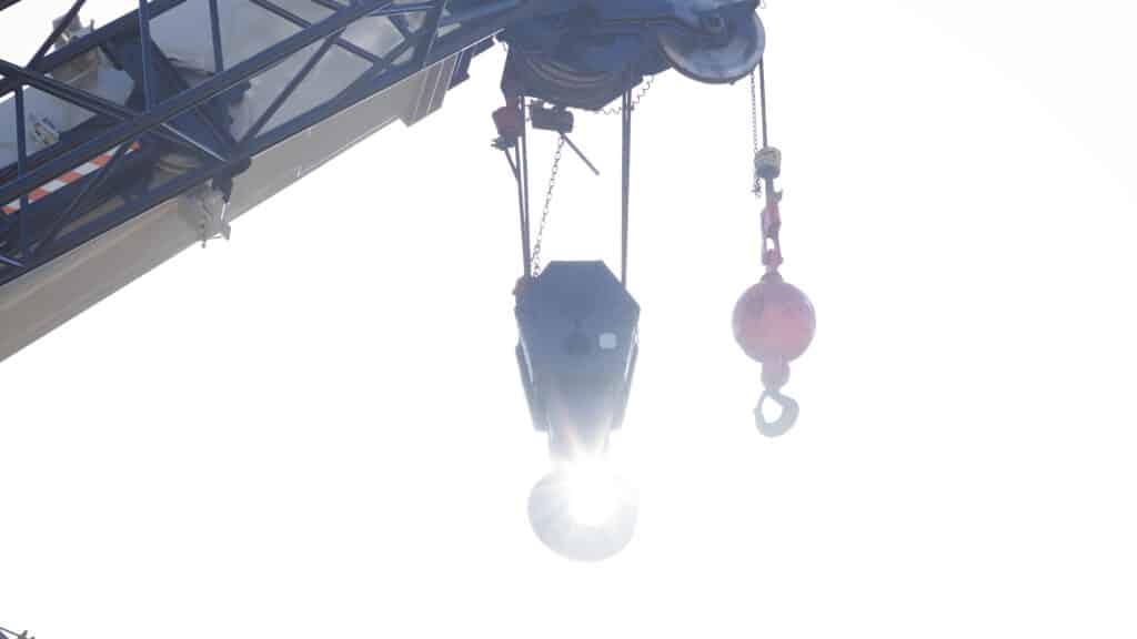 closeup of a crane rental part with the sun beaming through the center