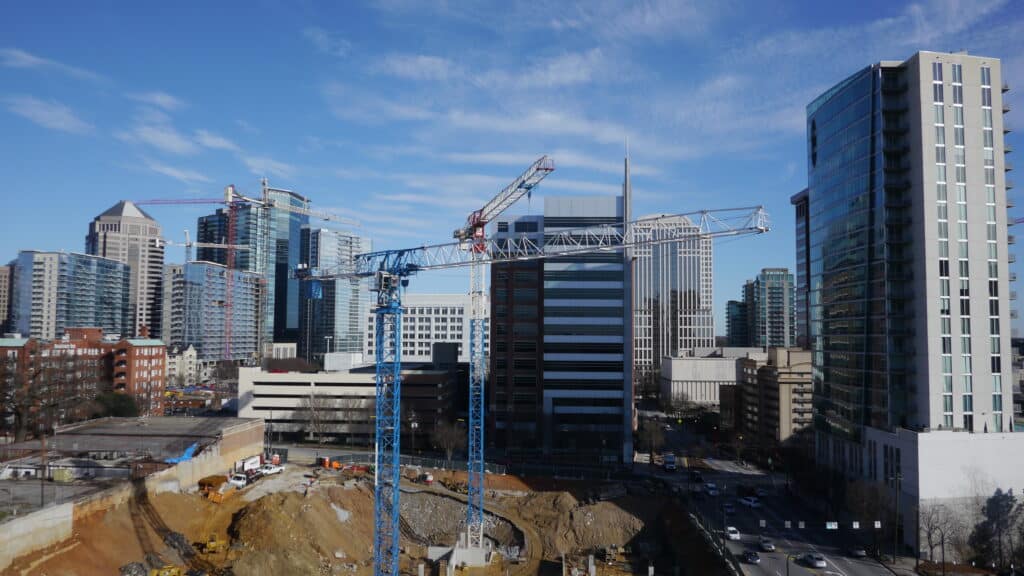 tower cranes in foreground of a city