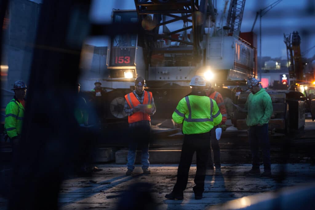 Maxim-Crane workers at night